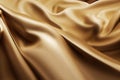 Gold silk satin fabric background. Wavy soft folds of golden fabric. Shiny fabric surface