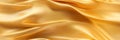 Gold silk satin. Soft folds. Fabric. Gold luxury background. Royalty Free Stock Photo