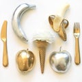 Flat lay Phot - Gold and silver apples, bananas, tableware