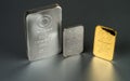 Gold and silver bars of different weight on a dark Royalty Free Stock Photo