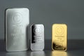 Gold and silver bars of different weight on a gray Royalty Free Stock Photo