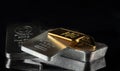 Gold and silver bars of various weights on a dark background. Royalty Free Stock Photo