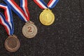 Gold, silver and bronze medals with numbers One, Two, Three and ribbons. Royalty Free Stock Photo