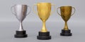 Gold silver bronze trophy cup with dual handle on grey background. Shiny metallic reward. 3d render Royalty Free Stock Photo