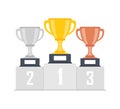 Gold, silver, bronze trophy cup, goblet on podium, pedestal isolated on background. 1st, 2nd, 3rd place. Handing awards to winner. Royalty Free Stock Photo