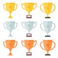 Gold, silver, bronze trophy in flat icons set. Royalty Free Stock Photo