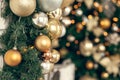 Gold and silver Christmas toys, balls garlands on a spruce branch Royalty Free Stock Photo