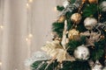 Gold and silver Christmas toys, balls garlands on a spruce branch with copy space Royalty Free Stock Photo