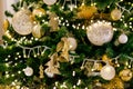 Gold and silver Christmas toys, balls and garlands on a spruce branch on christmas tree Royalty Free Stock Photo