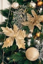 Gold and silver Christmas toys, balls, golden flowers, garlands on a spruce branch Royalty Free Stock Photo