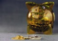 Gold and silver coins on a blurred background with a yellow transparent piggy bank. Royalty Free Stock Photo