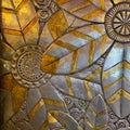 Gold and silver floral design on a wall