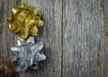 Gold and Silver Holiday Bow on Rustic Wood