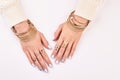 Gold and silver jewelry on women`s hands. Royalty Free Stock Photo