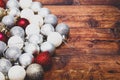 Gold,silver and red christmas baubles on a wooden background