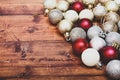 Gold,silver and red christmas baubles on a wooden background