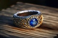 Gold silver ring with sapphire and diamonds on old wooden table, generative AI Royalty Free Stock Photo