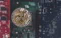 Gold Silver Ripple Coin Against Blurry Integrated Circuit Background