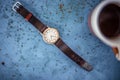 Gold/silver vintage wrist watch with brown leather bracelet.