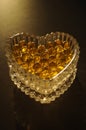gold small balls in glass shape heart