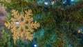 Gold snowflake ornament closeup on Christmas tree. Royalty Free Stock Photo