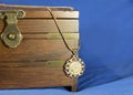 Gold sovereign coin as woman pendant on wooden present box