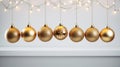 Gold sparkling holiday ornaments gracefully hanging from a fir branch against a pristine white background highlight the Royalty Free Stock Photo