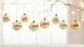 Gold sparkling holiday ornaments gracefully hanging from a fir branch against a pristine white background highlight the Royalty Free Stock Photo