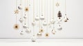 Gold sparkling holiday ornaments gracefully hanging from a fir branch against a pristine white background highlight the Royalty Free Stock Photo