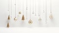 Gold sparkling holiday ornaments gracefully hanging from a fir branch against a pristine white background highlight the Royalty Free Stock Photo