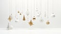 Gold sparkling holiday ornaments gracefully hanging from a fir branch against a pristine white background highlight the Royalty Free Stock Photo