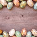 Gold speckled Easter egg double border on a square light wood background