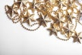 Gold star and bead garland on white backgroun. Flat lay. Top view