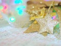 A gold star for Christmas decorations on knit fabric and a colorful background with the concept of celebration,Christmas, New Year Royalty Free Stock Photo
