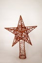 A gold star made of wire with yellow lights in the background Royalty Free Stock Photo