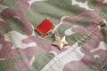 The Gold Star medal is a special insignia that identifies recipients of the title Hero in the Soviet Union on Soviet camouflag Royalty Free Stock Photo