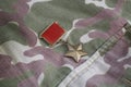 The Gold Star medal is a special insignia that identifies recipients of the title Hero in the Soviet Union on Soviet camouflag Royalty Free Stock Photo