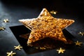 gold star-patterned cracker on a shiny glass surface Royalty Free Stock Photo