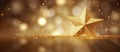 A gold star on a table with a blurred background in shades of brown and amber Royalty Free Stock Photo