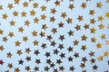 Gold stars texture on a blue background. top view