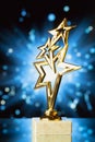 Gold stars trophy against shiny background Royalty Free Stock Photo