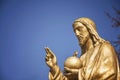 Gold statue Jesus Christ. He holds the sphere with a cross as a symbol of the trusteeship of Christianity above the earth Royalty Free Stock Photo