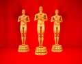 Gold statues on red.