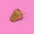 Gold strawberry on pink background Royalty Free Stock Photo