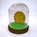 Gold stylized coin with the inscription nft in a case under a glass cover. crypto art concept. 3d render illustration