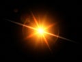 Gold sun with lens flare, glittering shiny star on black