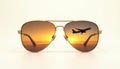 Gold sunglasses reflect sunset and airplane, white background Royalty Free Stock Photo