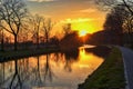 Gold sunset over river with sun rays, tree silhouettes and reflection on water