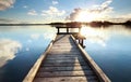 Gold sunshine over wooden pier on big lake Royalty Free Stock Photo