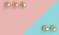 Gold tennis balls on a blue and pink background